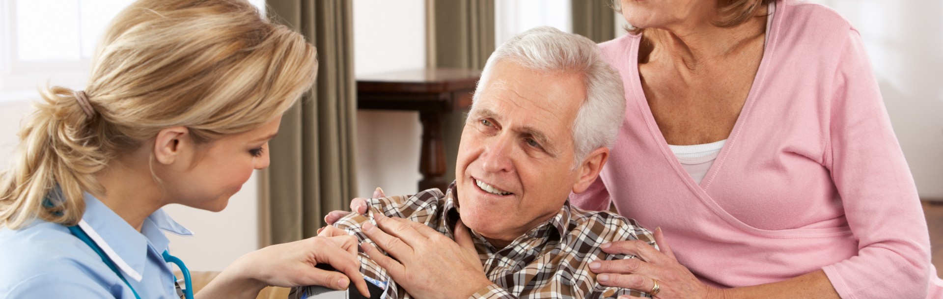 senior man looking at her young caregiver