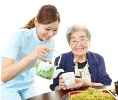 caregiver preparing food for her patient